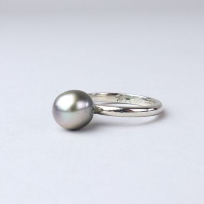 sterling silver ring with a black pearl on a white background
