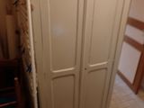 a white cabinet in the corner of a room