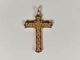an image of a gold cross on a white surface