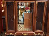 a wooden cabinet with a mirror on top of it