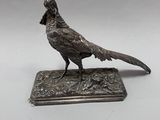 un oiseau perché sur une assiette en argent