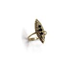 a close up of a gold ring with black stones on it