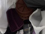 a pile of clothes and other items on a bed