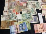 a lot of different bank notes on a black table