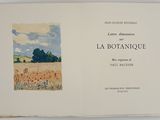 an open book with a picture of a field of flowers on it
