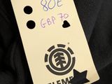 someone is holding a tag with the name of a skateboarder