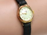 a woman ' s wrist that has a watch on it