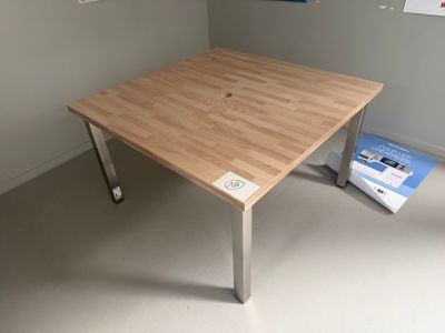 a wooden table with a book on it in a room