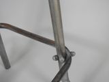 a close up of a metal bar stool with a metal seat
