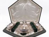 silverware in a black case with green handles and spoons in it