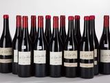 six bottles of red wine are lined up in a row