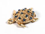 an image of a gold turtle broochle with blue stones