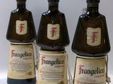 trois bouteilles de vin sont alignées sur une surface blanche