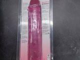 the pink vibrating toy is in the packaging on the table
