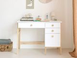 a white desk with a white cabinet and a white rug