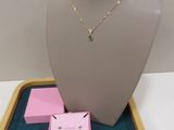 necklace and earring set in a display case on a table