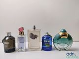 several different types of perfume bottles lined up on a white surface