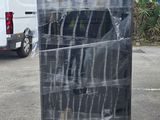 a large black box sitting on a pallet in a parking lot