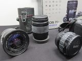 many cameras sitting on a table next to each other