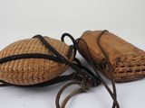 pair of vintage wicker purses on white background with strap