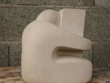 a white sculpture sitting on top of a wooden table