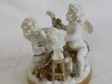 two figurines of angels sitting on a table