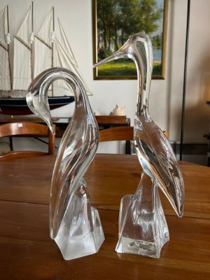 two glass birds sitting on a table in a living room