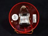 a watch sitting on a red plate with a price tag