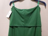 a close up of a green dress hanging on a hanger