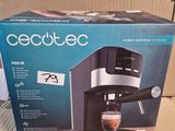the box is open to show the contents of a coffee machine
