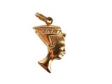 a close up of a gold pendant with an egyptian head on it
