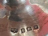 a close up of a silver plate with a name on it