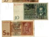 a group of five different bank notes on a white background