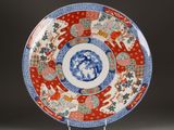 a red and blue plate with a design on it