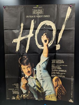 a movie poster of a man holding a gun in his hand