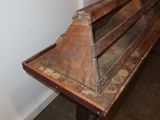 a wooden bench that is in the corner of a room