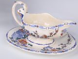 a blue and white bowl and saucer on a plate
