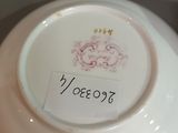 a white plate with a pink design on it