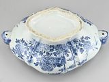 a blue and white bowl with a lid on a table