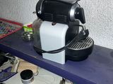 a coffee machine sitting on top of a blue shelf