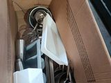 a cardboard box with a bunch of kitchen utensils inside of it