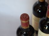 three bottles of wine that are sitting on a table