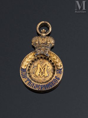 a close up of a gold medal with a crown on it