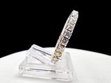 an image of a diamond ring sitting on top of a clear piece of glass