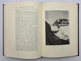an open book with a picture of a mountain in it