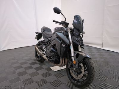 a motorcycle that is parked in a room with a checkered floor