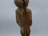 statue of a person with a broken arm holding a stick