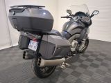 a motorcycle that is parked in a room with a checkered floor