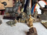 a lot of antique brass figurines sitting on a table