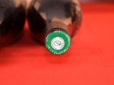 two bottles of beer sitting on a red table